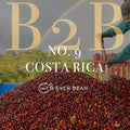 En stor bunke Costa Rica-kaffekirsebær bliver skovlet udendørs under en regnbue med teksten "No. 09 - Costa Rica (b)" og EverBean Business-logoet over.