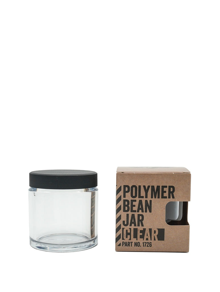 En klar Comandante Polymer Bean Jar med låg, Klar er vist ved siden af en brun æske mærket "Polymer Bean Jar Clear Part No. 1726" med en udskæring, der viser den kompatible krukke til din Comandante C40.