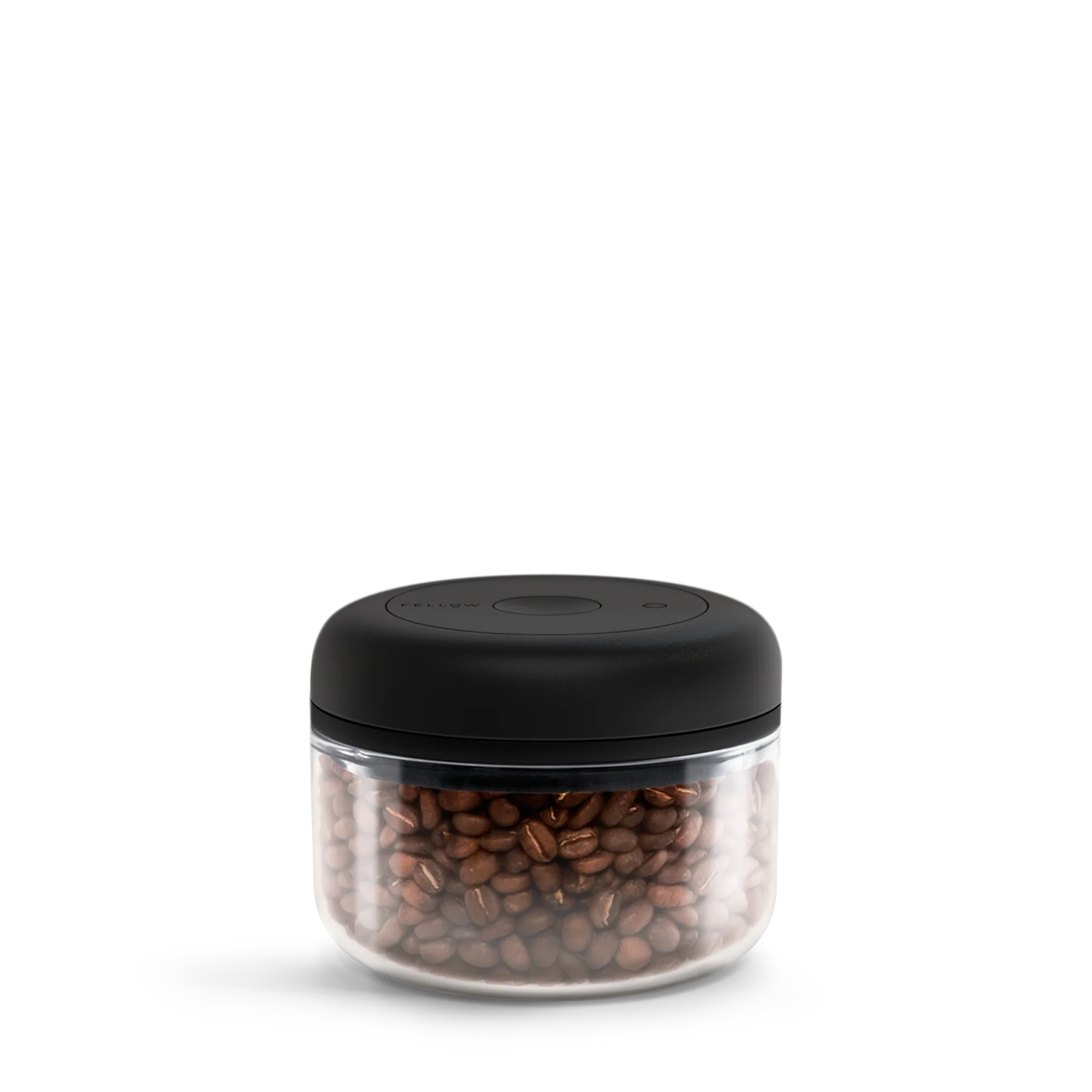 Fellow Atmos Vakuum Beholder by Fellow er en klar rund beholder til opbevaring af kaffebønner med sort låg og centerknop. Denne lufttæt kaffedåse fremhæver friskhed og stil, sat mod en almindelig hvid baggrund.