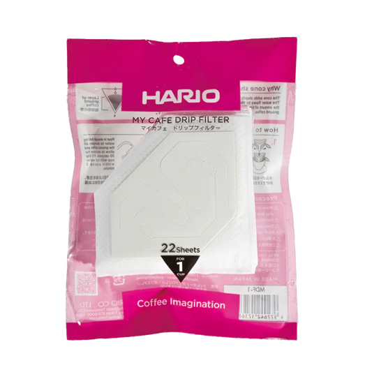 En pink og hvid pakke med Hario, en kop drypfilter fra Hario, indeholder 22 engangskaffefiltre til en kop. Emballagen viser japansk og engelsk tekst med et synligt filter indeni.