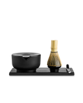 Fellow Matcha-sættet – Komplet Matcha-sæt fra Fellow består af en moderne sort skål, en bambuspisker, en metalske og et rektangulært bakke, der er anbragt på en hvid baggrund – perfekt til dit matcha-ritual.